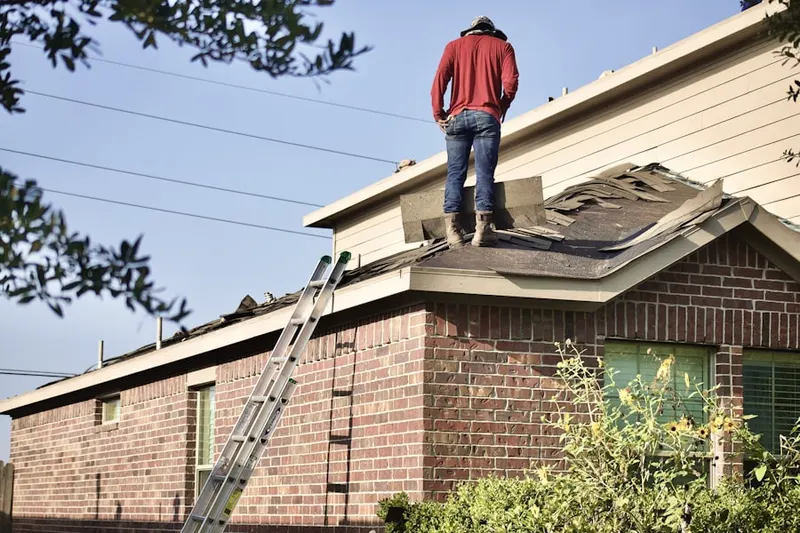 Professional roofer working on a residential roof in Pewaukee